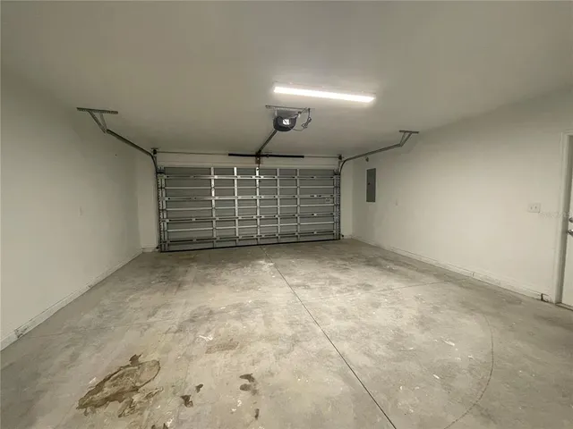 a view of an empty room with brick wall and windows