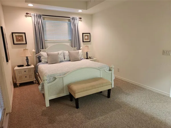 a bedroom with a bed and a night stand