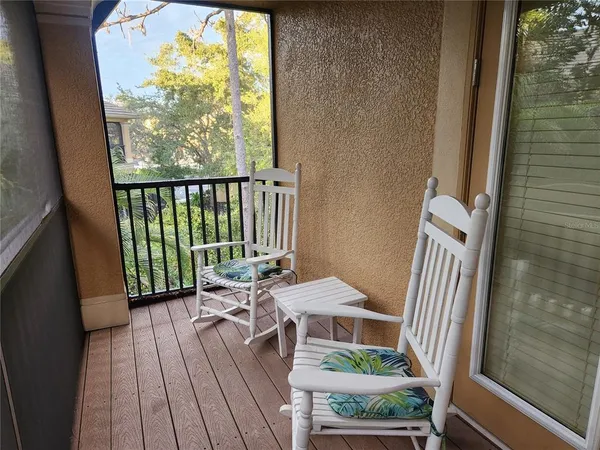a balcony with table and chairs