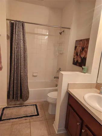 a bathroom with a sink a toilet a tub and shower