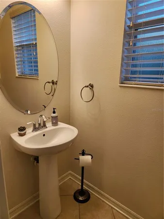 a bathroom with a sink a mirror and shower