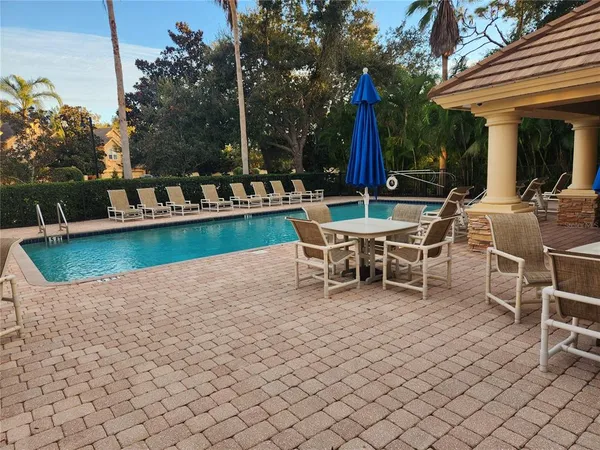 a view of a patio with a table and chairs