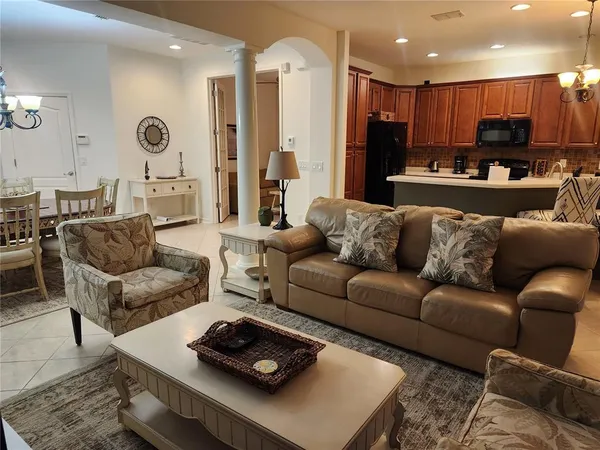 a living room with furniture kitchen and a table