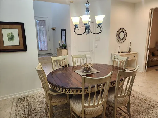 a view of a dining room with furniture and chandelier