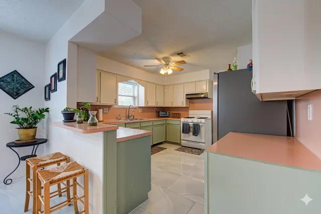 a kitchen with cabinets and window