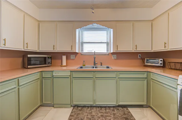 a kitchen with a sink cabinets and window