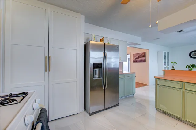 a kitchen with a refrigerator and a stove