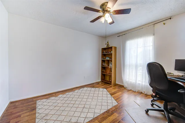 a view of workspace with wooden floor and lounge chair