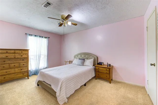 a bedroom with a bed and cabinets