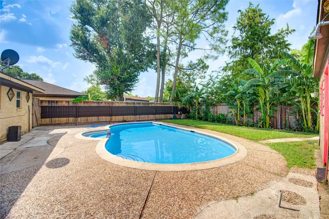 a view of backyard with swimming pool and outdoor seating