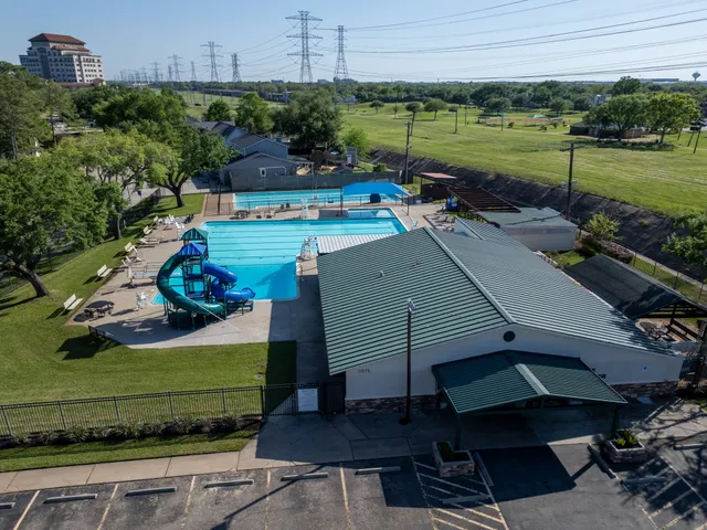 an aerial view of a house with a yard basket ball court and outdoor seating