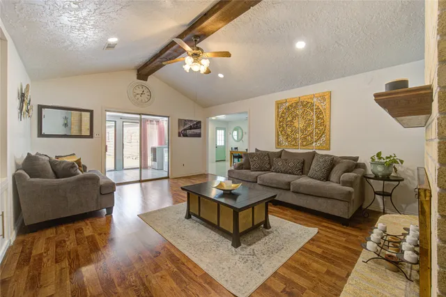 a living room with furniture and a dining table
