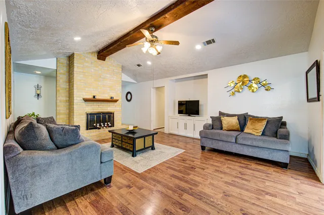 a living room with furniture and a fireplace