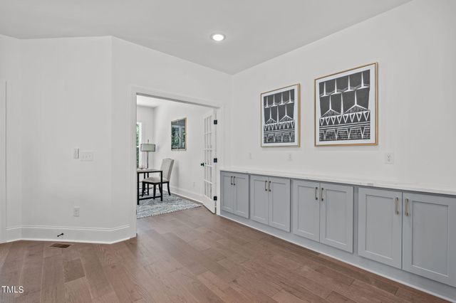 a view of a kitchen with wooden floor and windows