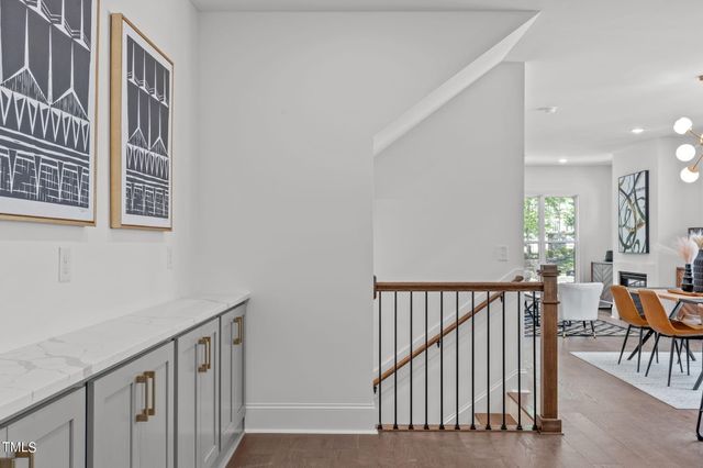 a view of a hallway with wooden floor and stairs