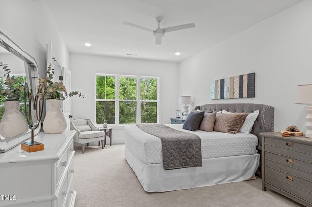 a bedroom with a large bed and a large window