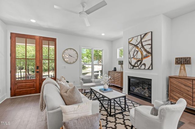 a living room with furniture a fireplace and a large window