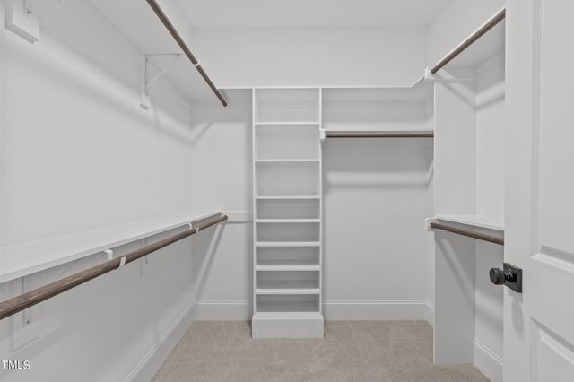 a view of walk in closet with empty racks