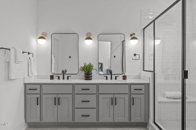 a bathroom with a double vanity sink and a mirror