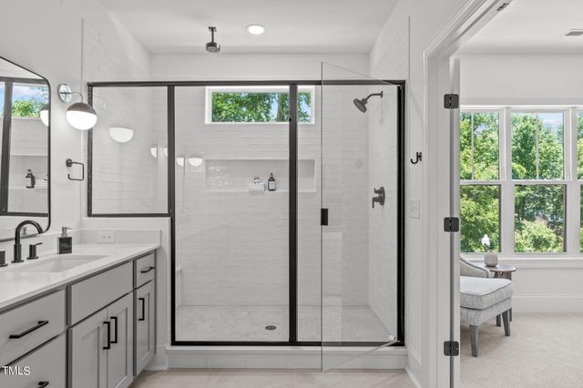 a bathroom with a glass shower door and a sink