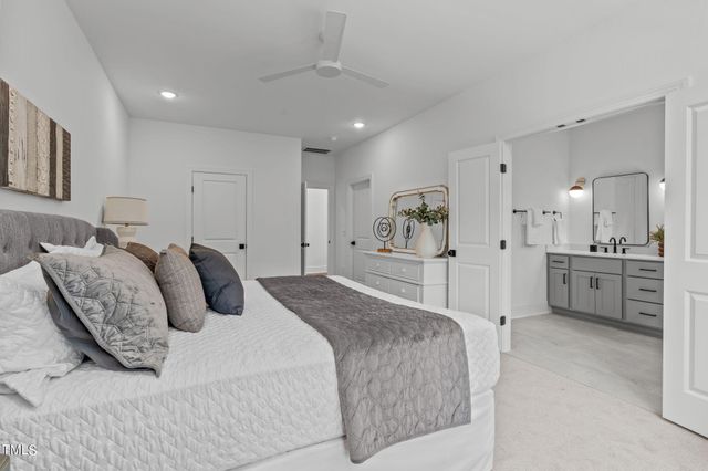 a spacious bedroom with a bed and a view of bathroom