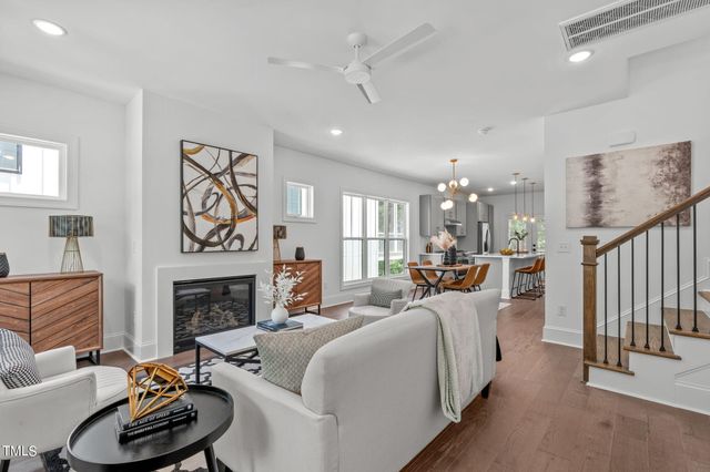 a living room with furniture fireplace and window