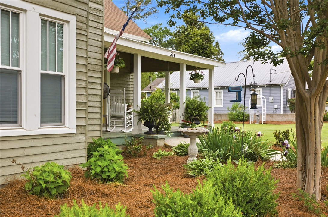 314 South Fairplay Street Seneca, SC 29678 - Photo 3 of 50 This charming residence features a welcoming front porch, lush landscaping, and a well-maintained yard.