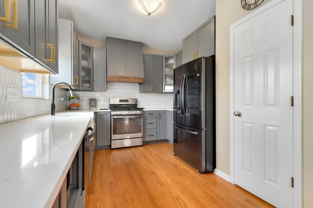 Undisclosed Address Bartlett, IL 60103 - Photo 13 of 45 a kitchen with granite countertop stainless steel appliances a refrigerator a sink a stove and cabinets