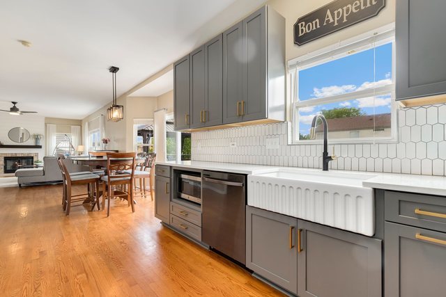 Undisclosed Address Bartlett, IL 60103 - Photo 14 of 45 a kitchen with stainless steel appliances granite countertop sink stove top oven and cabinets