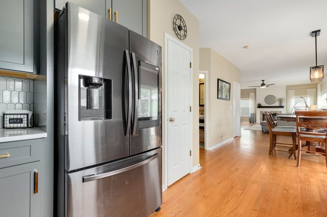 Undisclosed Address Bartlett, IL 60103 - Photo 15 of 45 a kitchen with stainless steel appliances a refrigerator stove and wooden floor