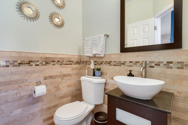 Undisclosed Address Bartlett, IL 60103 - Photo 19 of 45 a bathroom with a toilet a sink and mirror