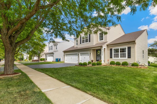 Undisclosed Address Bartlett, IL 60103 - Photo 2 of 45 a front view of a house with a garden