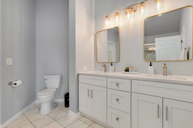 Undisclosed Address Bartlett, IL 60103 - Photo 24 of 45 a bathroom with a toilet sink and mirror