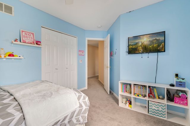 Undisclosed Address Bartlett, IL 60103 - Photo 30 of 45 a bedroom with furniture and a flat screen tv