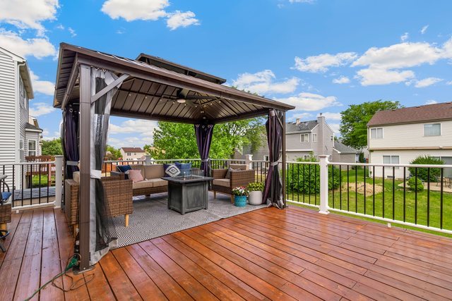Undisclosed Address Bartlett, IL 60103 - Photo 38 of 45 a view of a patio with lawn chairs floor to ceiling window and wooden floor