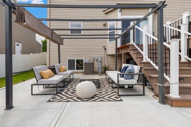 Undisclosed Address Bartlett, IL 60103 - Photo 40 of 45 a outdoor space with patio the couches and a fireplace with the potted plants