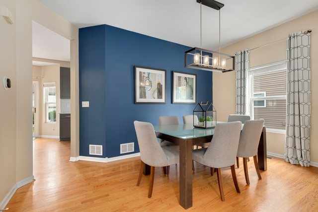 Undisclosed Address Bartlett, IL 60103 - Photo 7 of 45 a view of a dining room with furniture window and wooden floor