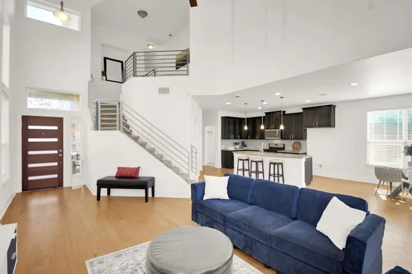 a living room with furniture and kitchen view