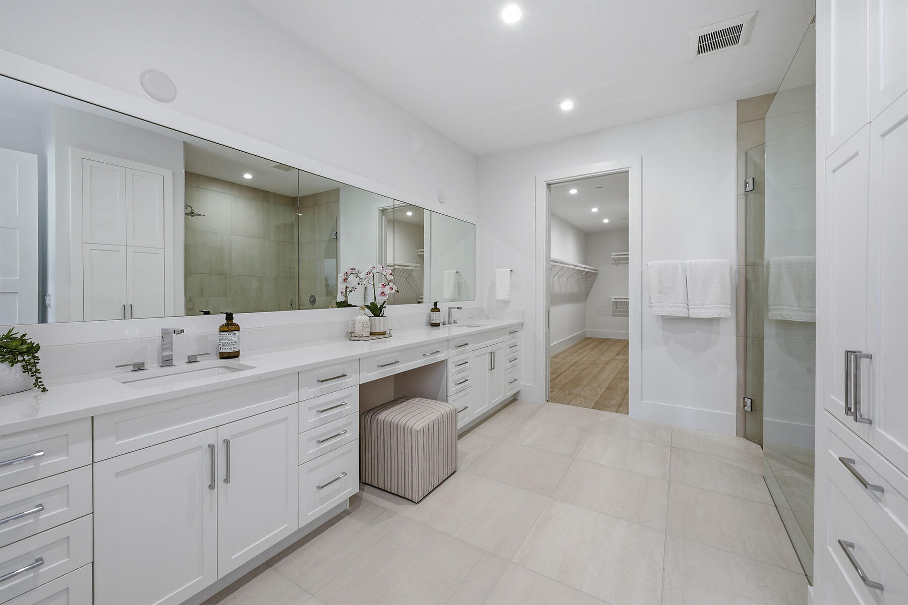 3291 Dorado Lane, Unit 101 Naples, FL 34114 - Photo 12 of 50 a spacious bathroom with a double vanity sink a mirror and a shower