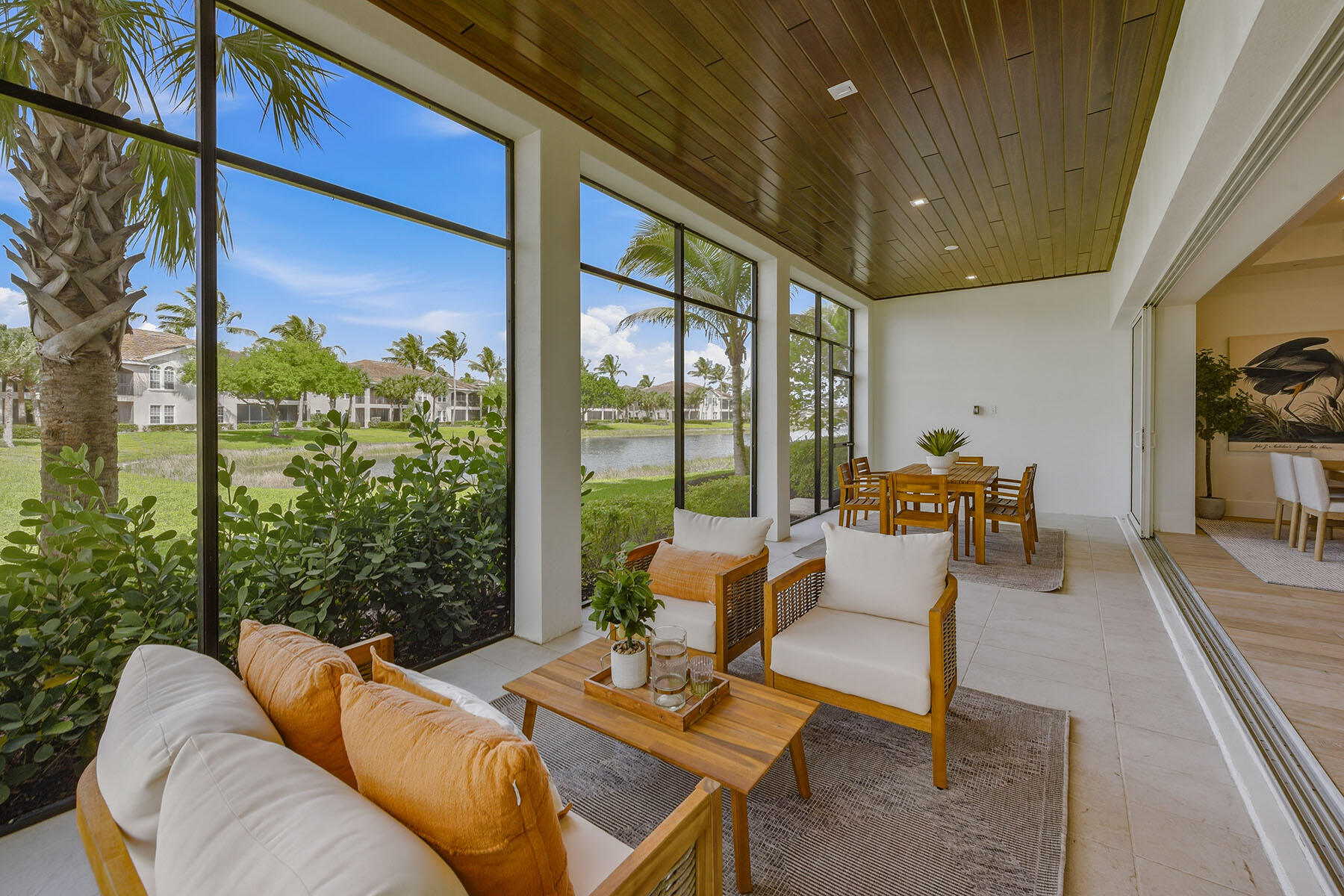 3291 Dorado Lane, Unit 101 Naples, FL 34114 - Photo 2 of 50 a living room with patio furniture and a floor to ceiling window