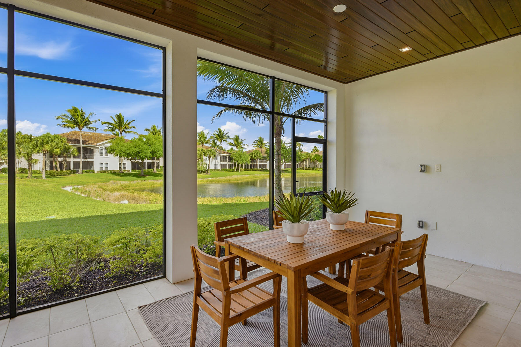 3291 Dorado Lane, Unit 101 Naples, FL 34114 - Photo 25 of 50 a view of an outdoor kitchen with a table and chairs