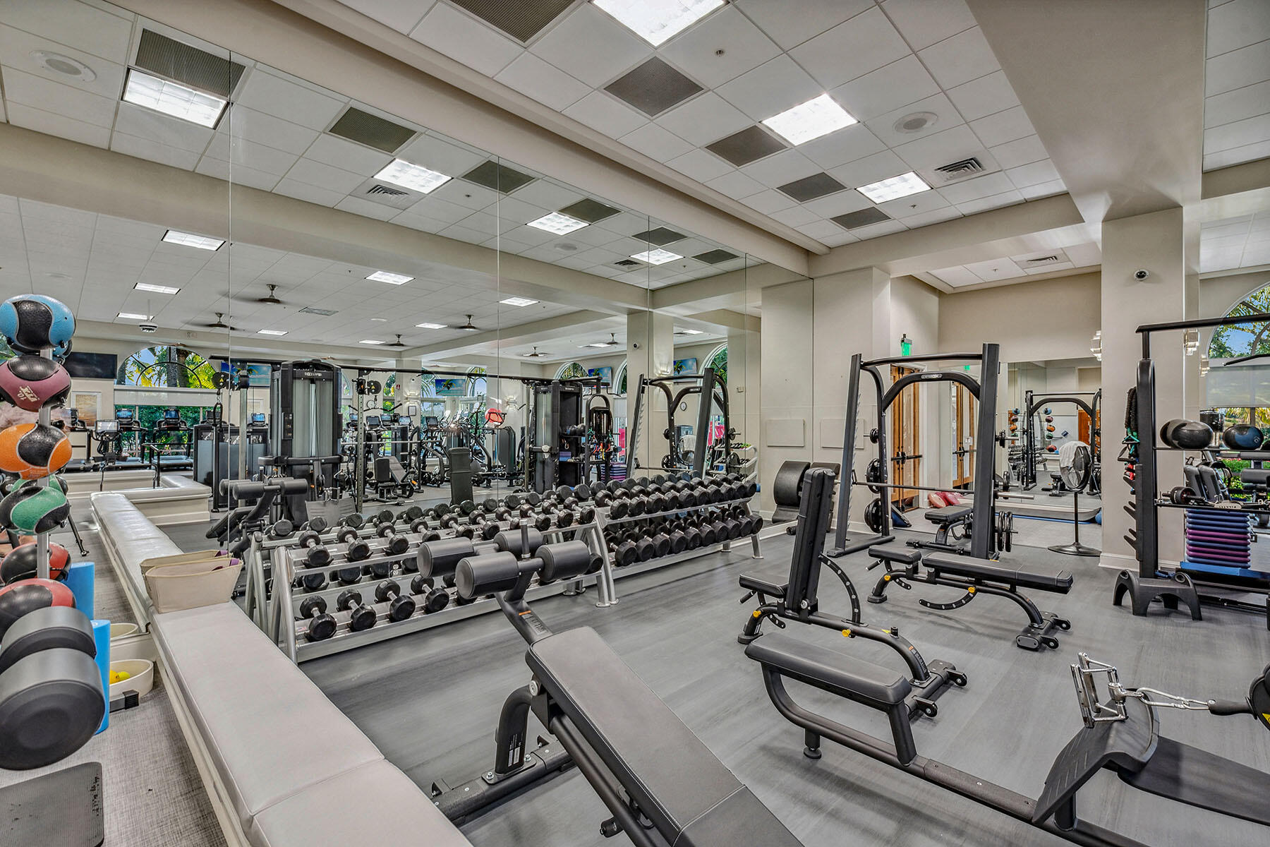 3291 Dorado Lane, Unit 101 Naples, FL 34114 - Photo 46 of 50 a room with gym equipment and lots of wooden walls