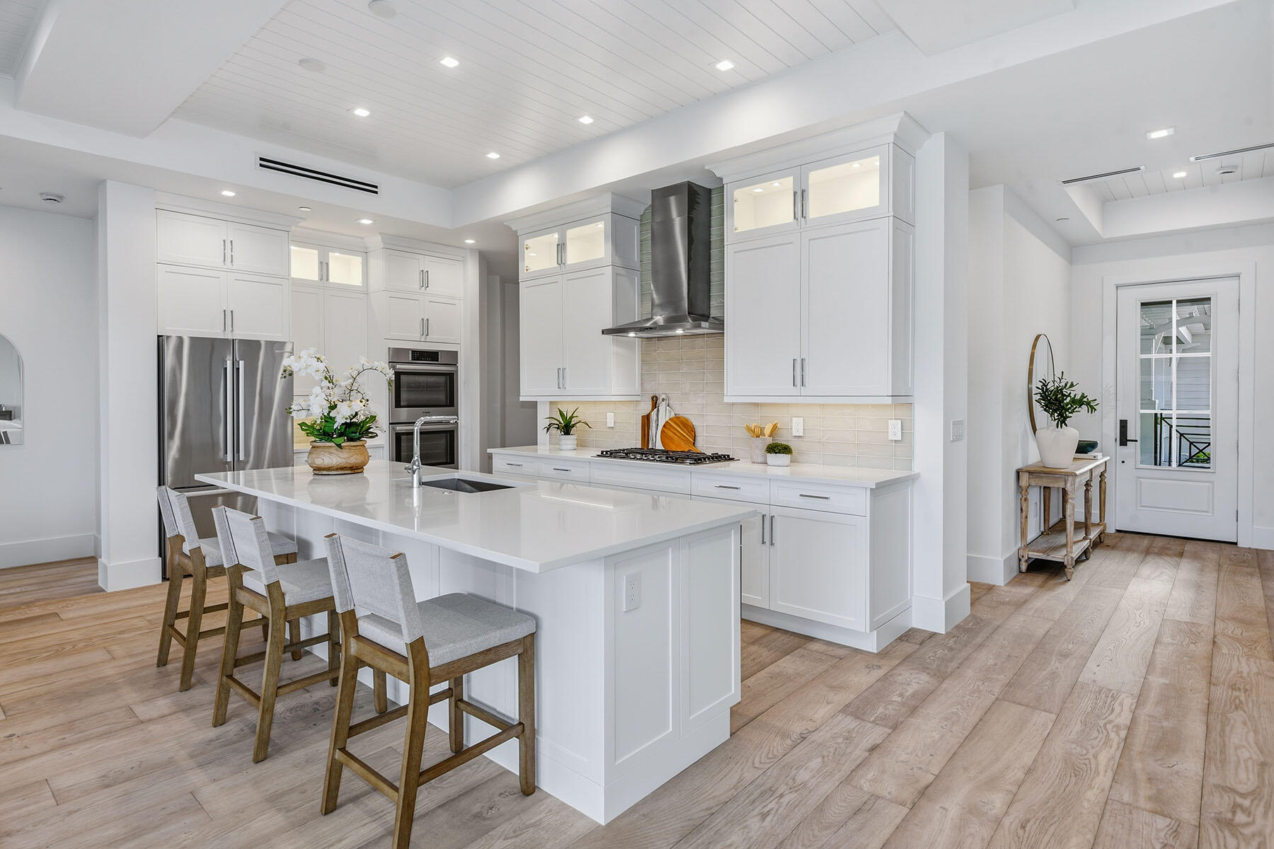 3291 Dorado Lane, Unit 101 Naples, FL 34114 - Photo 6 of 50 a kitchen with white cabinets and stainless steel appliances