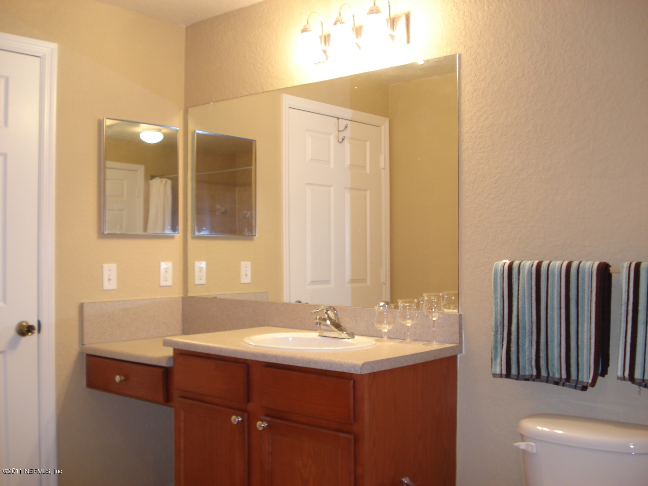 8550 Touchton Road, Unit 224 Jacksonville, FL 32216 - Photo 11 of 17 a bathroom with a sink and a mirror