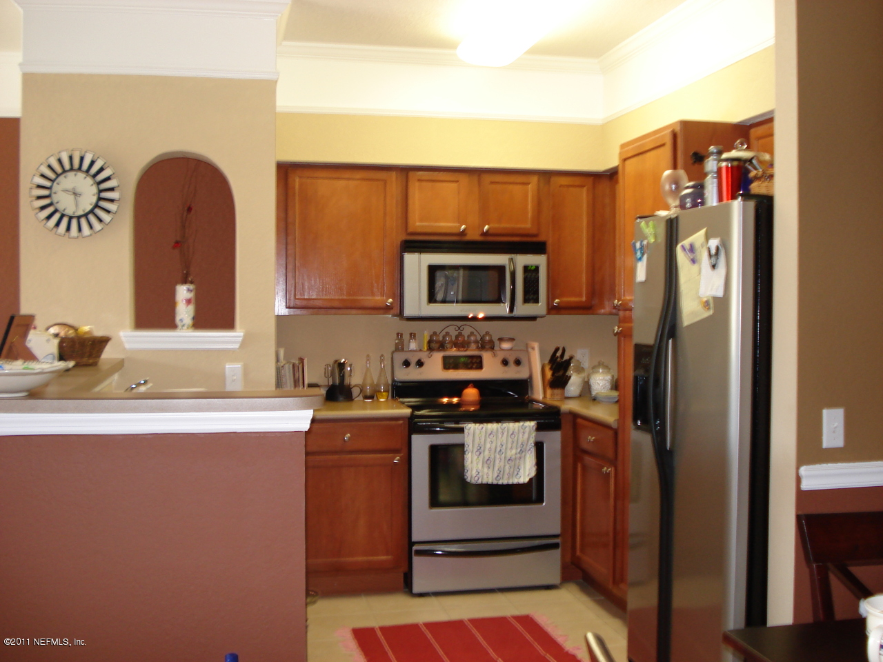 8550 Touchton Road, Unit 224 Jacksonville, FL 32216 - Photo 2 of 17 a kitchen with stainless steel appliances granite countertop a stove a sink and a refrigerator