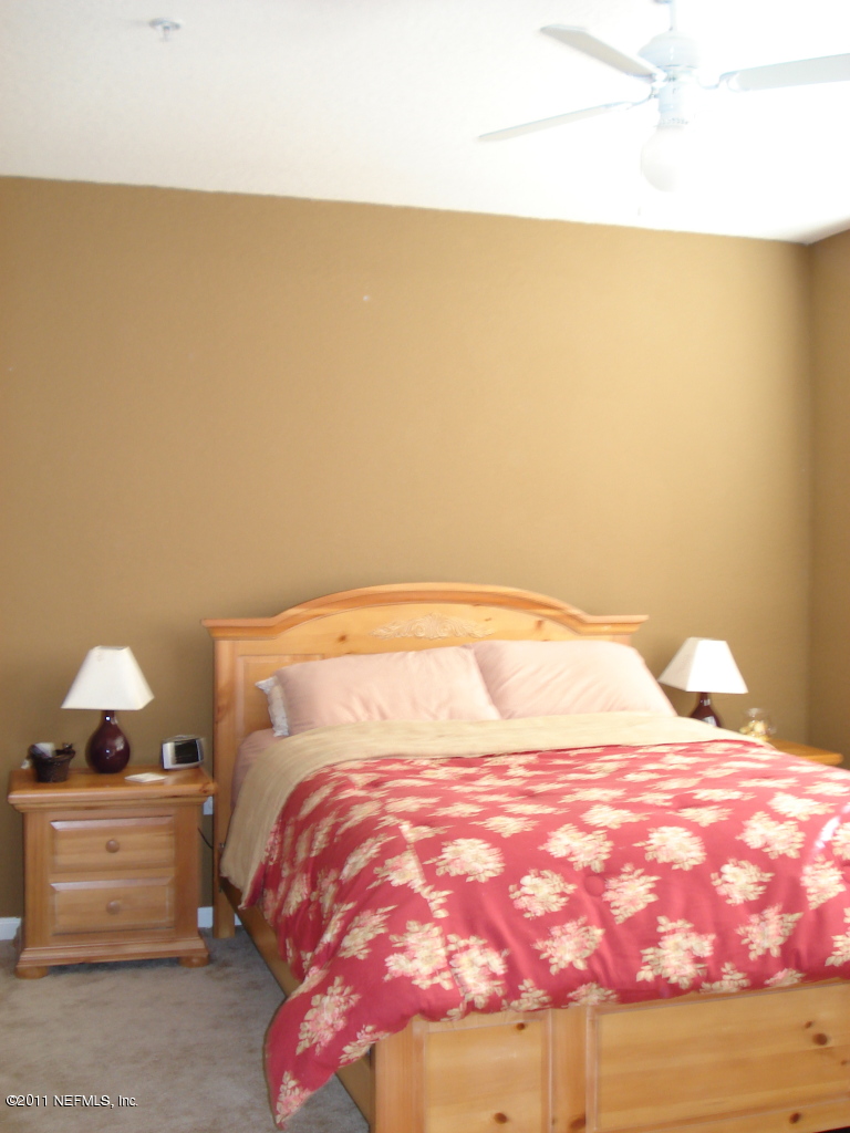 8550 Touchton Road, Unit 224 Jacksonville, FL 32216 - Photo 8 of 17 a bedroom with a bed and a night stand