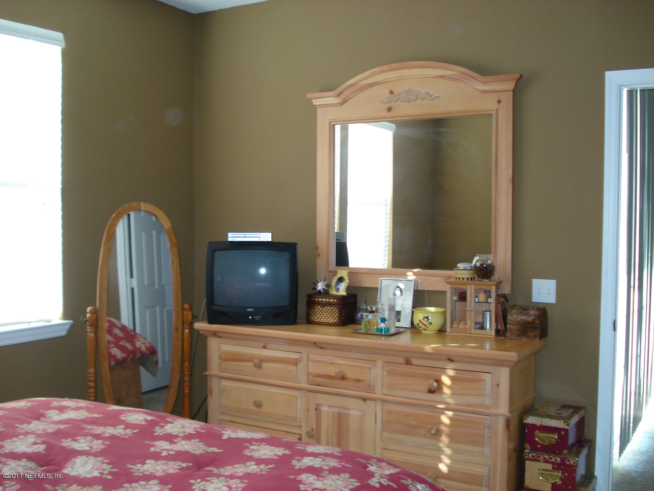 8550 Touchton Road, Unit 224 Jacksonville, FL 32216 - Photo 9 of 17 a bedroom with a bed and a mirror on dresser