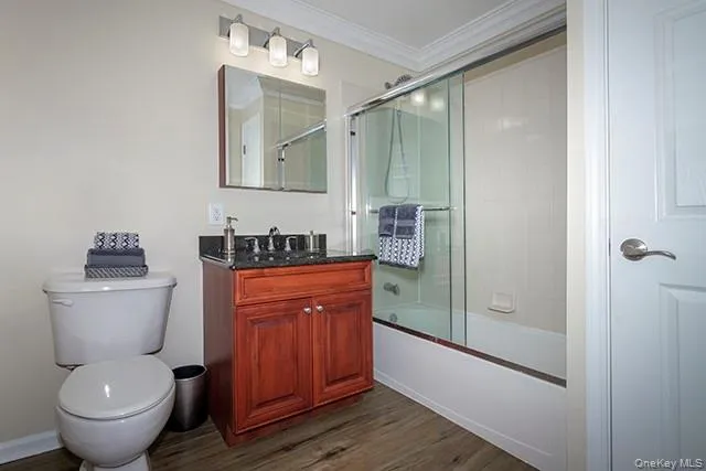 a bathroom with a granite countertop toilet sink and shower