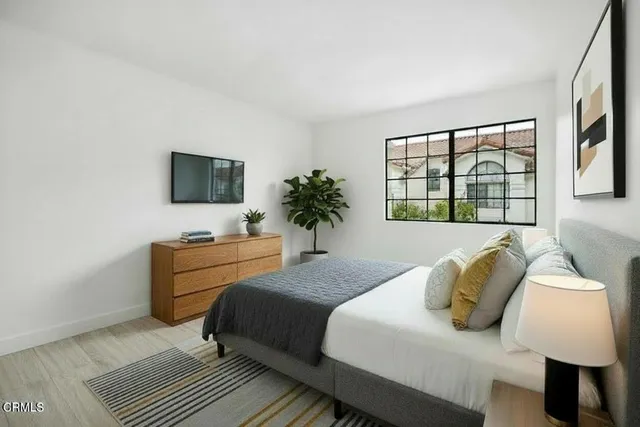 a bedroom with a bed and a window