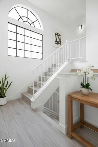 a view of a hallway with workspace and a window